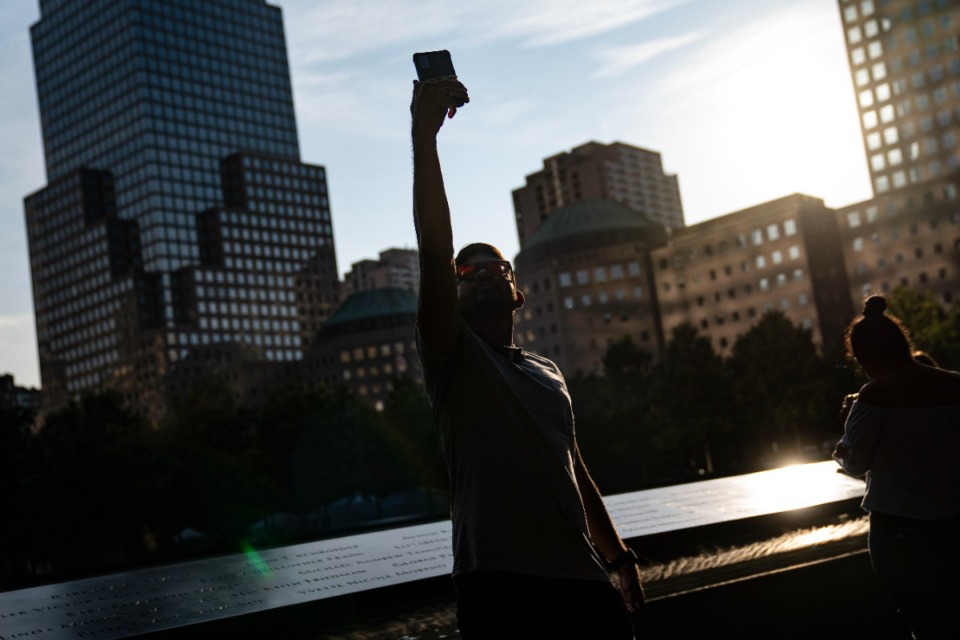 <strong>A visitor takes a selfie beside the north pool at the National September 11 Memorial &amp; Museum, Wednesday, Sept. 8, 2021, in New York.</strong> (John Minchillo/AP)