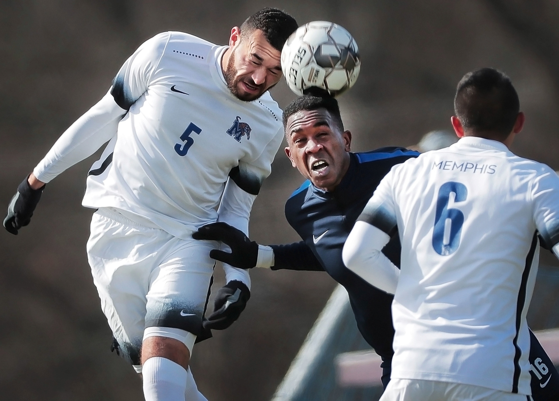<strong>Memphis 901 FC forward Heviel Cordoves (center) battles for a header with University of Memphis defender Justyn Thomas during an exhibition game against the Tigers soccer team at the U of M south campus on Feb. 9, 2019.</strong> (Jim Weber/Daily Memphian)