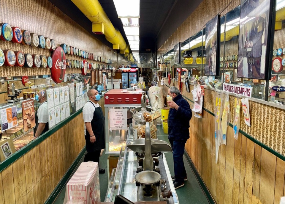 <strong>Rida AbuZaineh (right) tends to a customer in the peanut shop that is 8 feet wide on Main Street in Downtown Memphis.</strong> (Tom Bailey/Daily Memphian file)