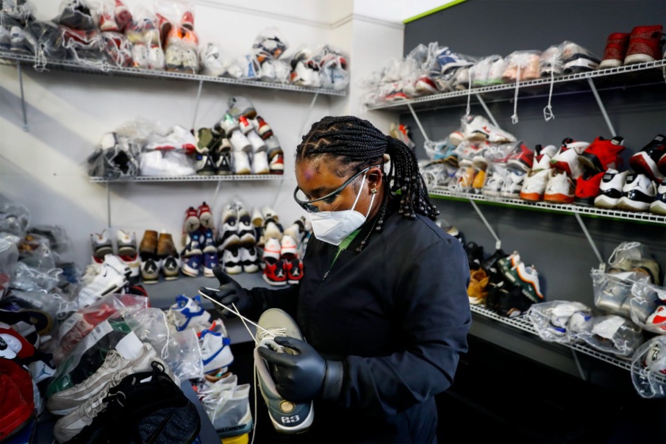 <strong>Nadia McDaniel pairs several shoes for cleaning and restoration at the Snkrr Bar.</strong> (Mark Weber/The Daily Memphian)
