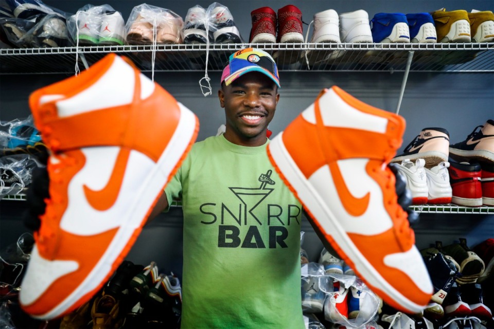 <strong>Snkrr Bar founder Dominique Worthen shows off a pair of restored Air Jordans at the recently opened business.</strong> (Mark Weber/The Daily Memphian)