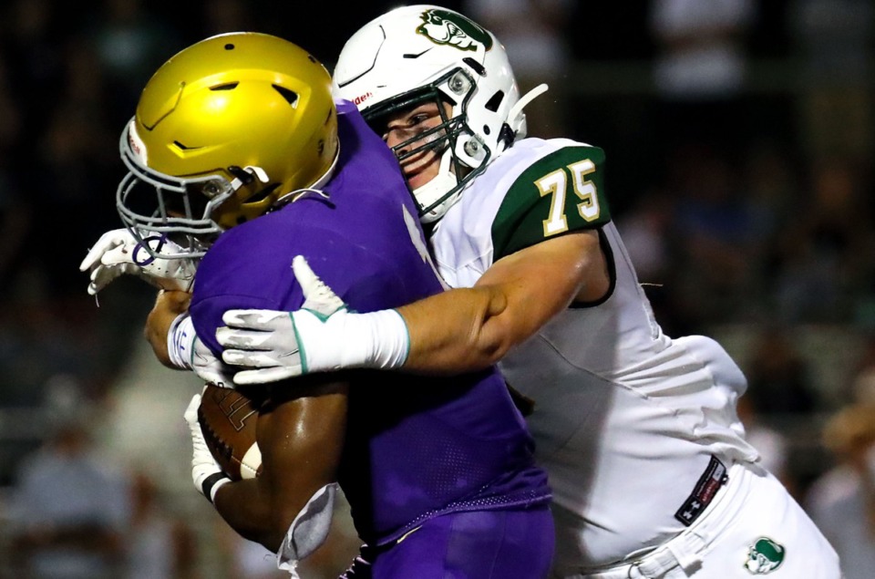 <strong>CBHS running back Dallan Hayden (1) gets tackled by Briarcrest Christian School lineman Nate Bledsoe (75) on Sept. 17.</strong> (Patrick Lantrip/Daily Memphian)