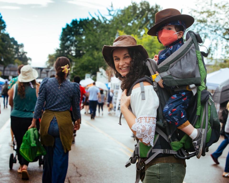 <strong>Jillian Atlas walks down Cooper Street with Oliver Tiberius Atlas in tow at Cooper-Young Festival in Midtown, Saturday, Sept. 18.</strong> (Ziggy Mack/Special to The Daily Memphian)