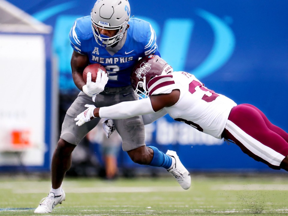 <strong>University of Memphis running back Rodrigues Clark (2) breaks a tackle from Mississippi State University safety Jay Jimison (36) during a Sept. 18, 2021 game at Liberty Bowl Memorial Stadium.</strong> (Patrick Lantrip/Daily Memphian)