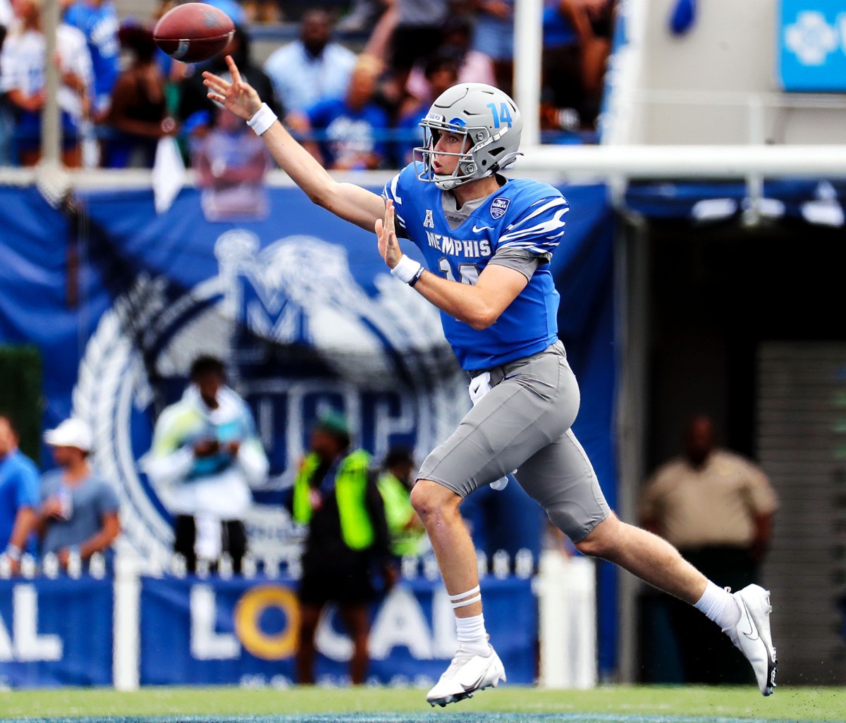 <strong>University of Memphis quarterback Seth Henigan (14) rolls out of the pocket to complete a pass Saturday against Mississippi State University.</strong> (Patrick Lantrip/Daily Memphian)