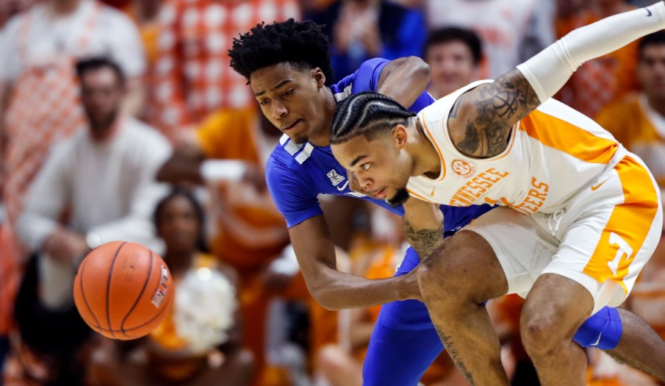 <strong>Lamonte Turner (1) battles for the loose ball with Memphis guard Jayden Hardaway (25) during the first half of an NCAA college basketball game Saturday, Dec. 14, 2019, in Knoxville, Tennessee.</strong> (AP Photo/Wade Payne)