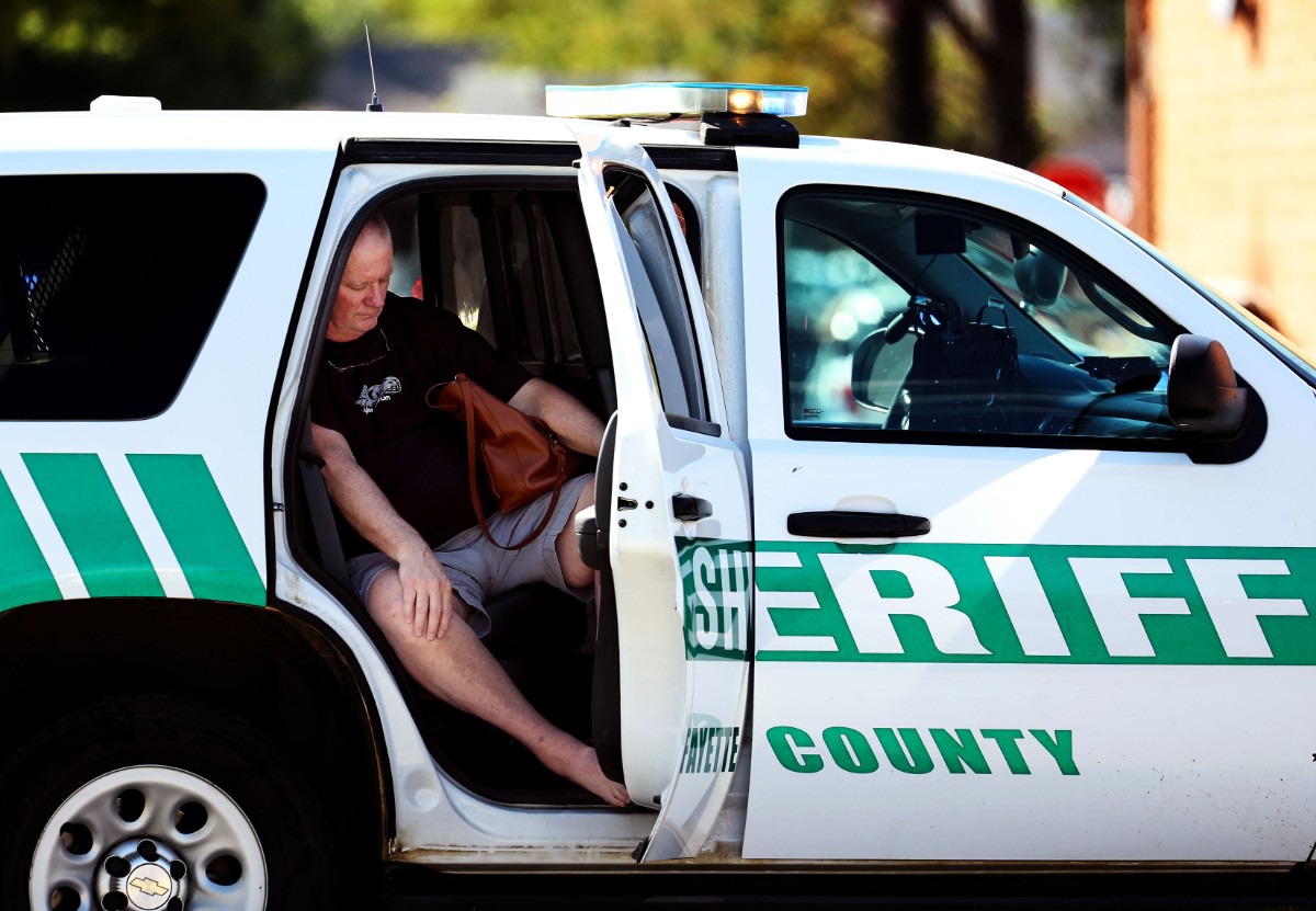 <strong>A survivor of the shooting sits in a Fayette County Sheriff&rsquo;s SUV in the Kroger parking lot.</strong> (Patrick Lantrip/Daily Memphian)