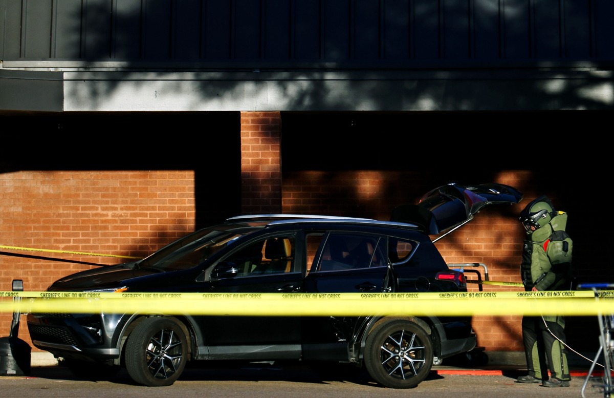 <strong>A member of the bomb squad inspects the vehicle of the suspect believed to be responsible for the mass shooting at a Kroger in Collierville on Sept. 23, 2021.</strong> (Patrick Lantrip/Daily Memphian)