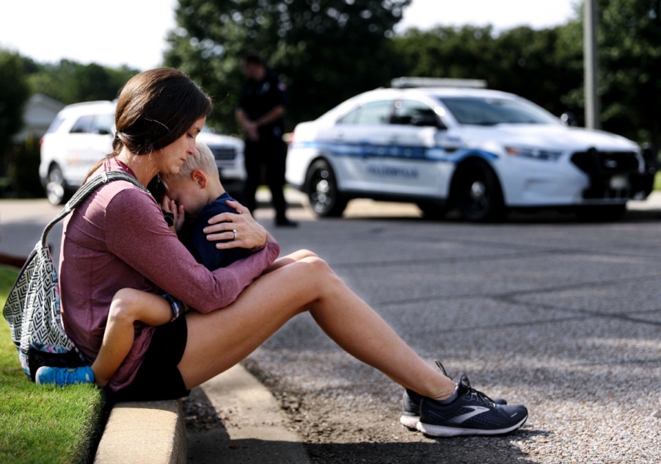 <strong>Carly McWatters holds her son at Collierville Town Hall Sept. 24, 2021, to pay their respects to the victims of the Kroger shooting the day before.</strong> (Patrick Lantrip/Daily Memphian)