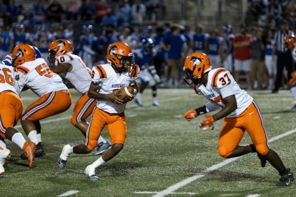 <strong>Ridgeway&rsquo;s quarterback Jeremiah Lucas hands the ball off to Markelle Phillips during Friday night&rsquo;s game at Memphis University School.</strong>&nbsp;(Brad Vest/Daily Memphian)