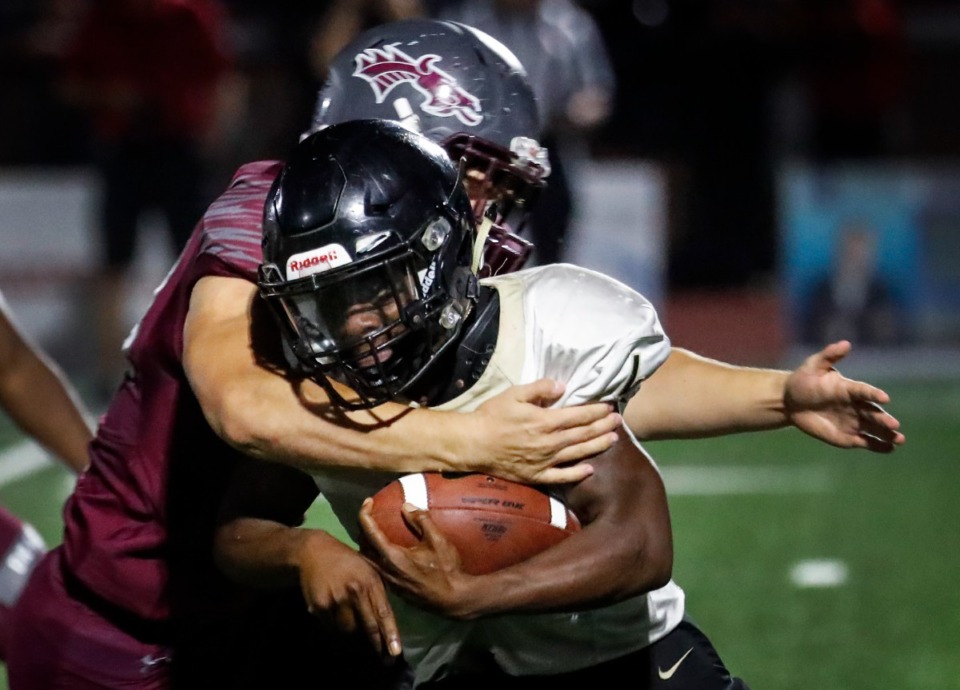 <strong>Collierville&rsquo;s Johnathan Davis (left) tackles Whitehaven running back Derrius Boddie (right) behind the line of scrimmage on Friday, Sept. 24, 2021.</strong> (Mark Weber/The Daily Memphian)