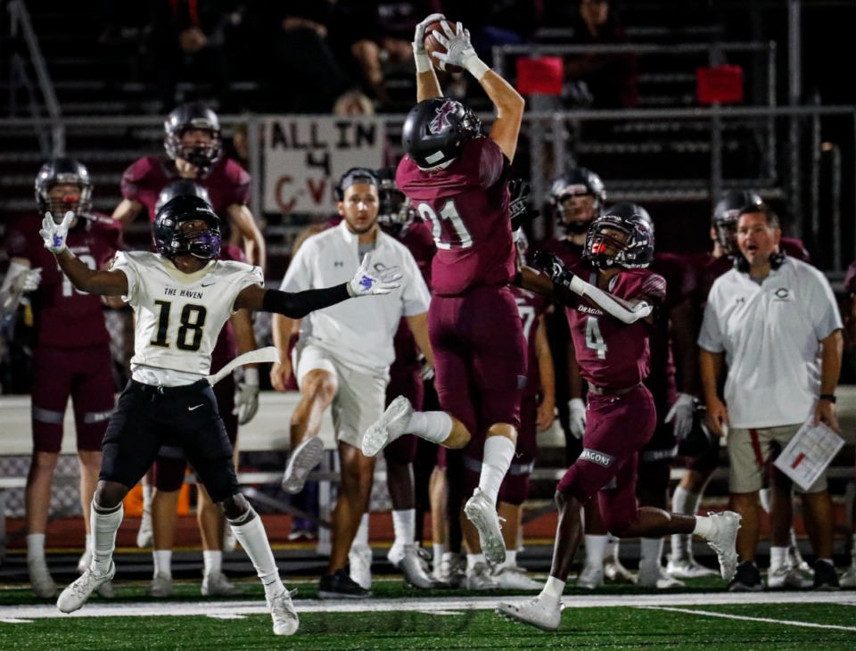 <strong>Collierville&rsquo;s Harrison Craig (middle) grabs an interception in front of Whitehaven receiver Donnell Frazier (left) on Friday, Sept. 24, 2021.</strong> (Mark Weber/The Daily Memphian)