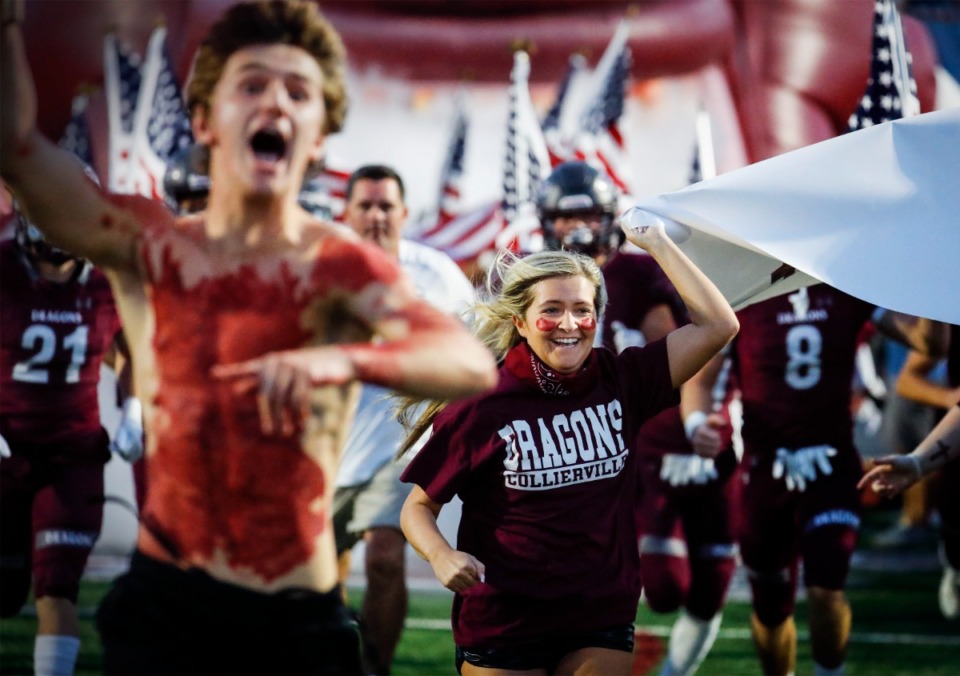 <strong>Collierville students run onto the field before the Dragons take on Whitehaven on Friday, Sept. 24, 2021.</strong> (Mark Weber/The Daily Memphian)