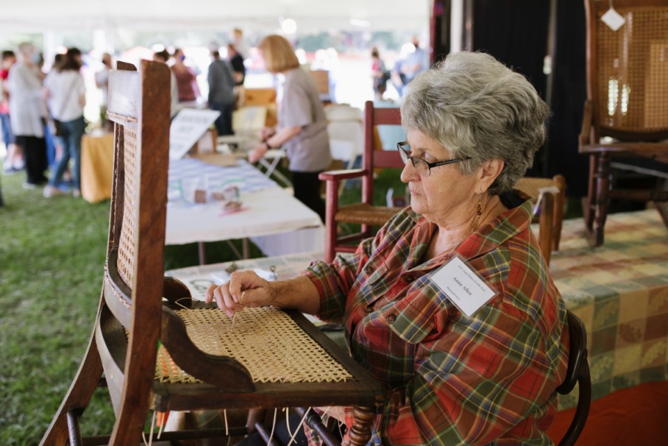 <strong>Anna Allen, a professional chair caner, demonstrates her craft at the Pink Palace Crafts Fair,&nbsp; Saturday, Sept. 25 at Audubon Park.</strong> (Lucy Garrett/Special to The Daily Memphian)