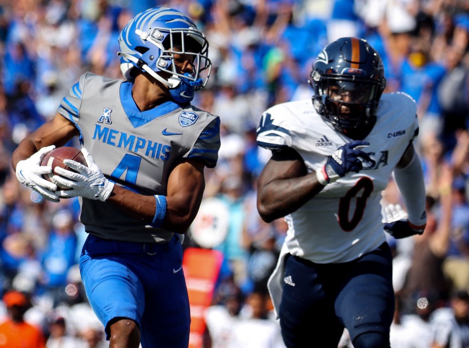 <strong>University of Memphis receiver Calvin Austin III (4) scrambles for a first down while being chased by University of Texas San Antonio safety Rashad Wisdom (0) Saturday at Liberty Bowl Memorial Stadium.</strong> (Patrick Lantrip/Daily Memphian)