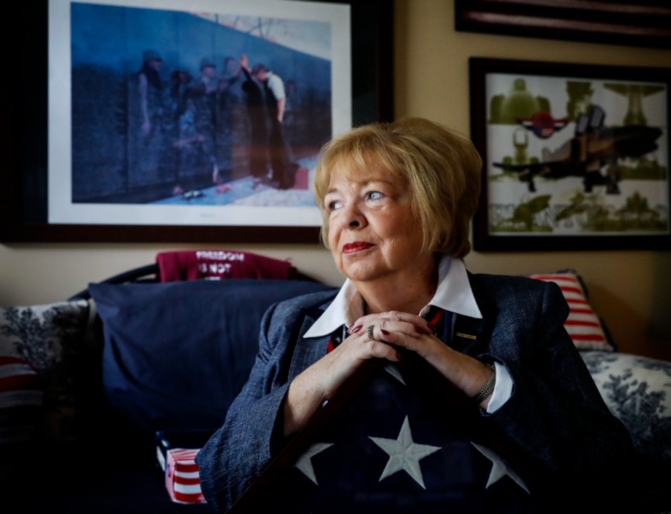 <strong>Candy Wells sits in her Collierville home, holding a flag given to her family after her brother, Army Specialist Five Rodney D. Osborne, was killed in Vietnam.</strong> (Mark Weber/The Daily Memphian)