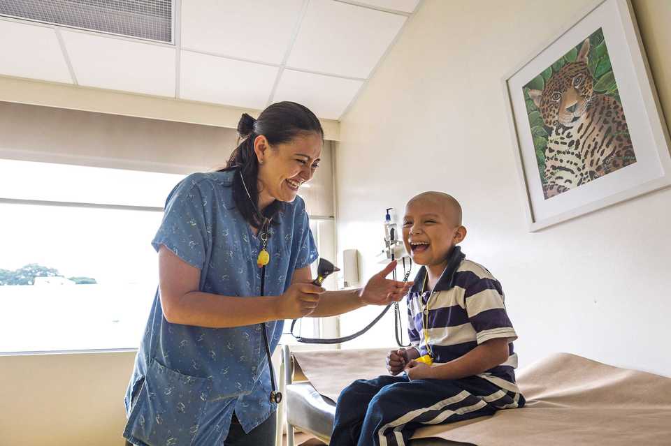 <strong>A medical professional checks a young patient at Unidad Nacional de Oncologia Pediatrica in Guatemala.</strong> (Photo courtesy of Scott A. Woodward)