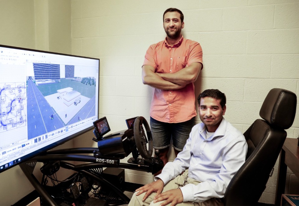 <strong>University of Memphis civil engineering associate professor Dr. Sabya Mishra (front) and his student Ali Ramhi Samani (back) sit for a portrait in the driving simulator lab on Tuesday, Sept. 28, 2021.</strong> (Mark Weber/The Daily Memphian)