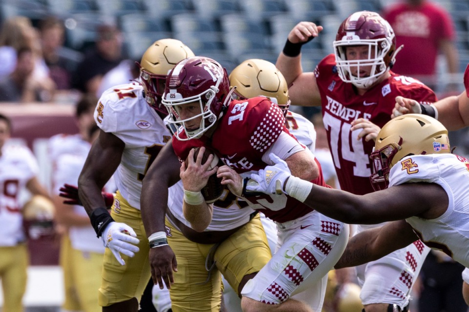 <strong>Temple quarterback Justin Lynch (13) attempts to break through the Boston College defensive line on Sept. 18 in Philadelphia. Lynch is one of two Temple quarterbacks the Tigers might face Saturday.</strong> (Tyger Williams/The Philadelphia Inquirer via AP)