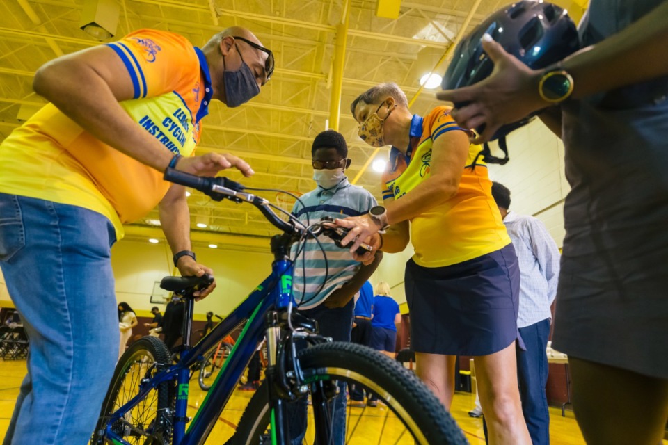 <strong>Carlos Rivera and his associates help Christopher Marshall get accustomed to his new bike at Douglass Community Center on Oct. 3, 2021.</strong>&nbsp;(Ziggy Mack/Special to The Daily Memphian)