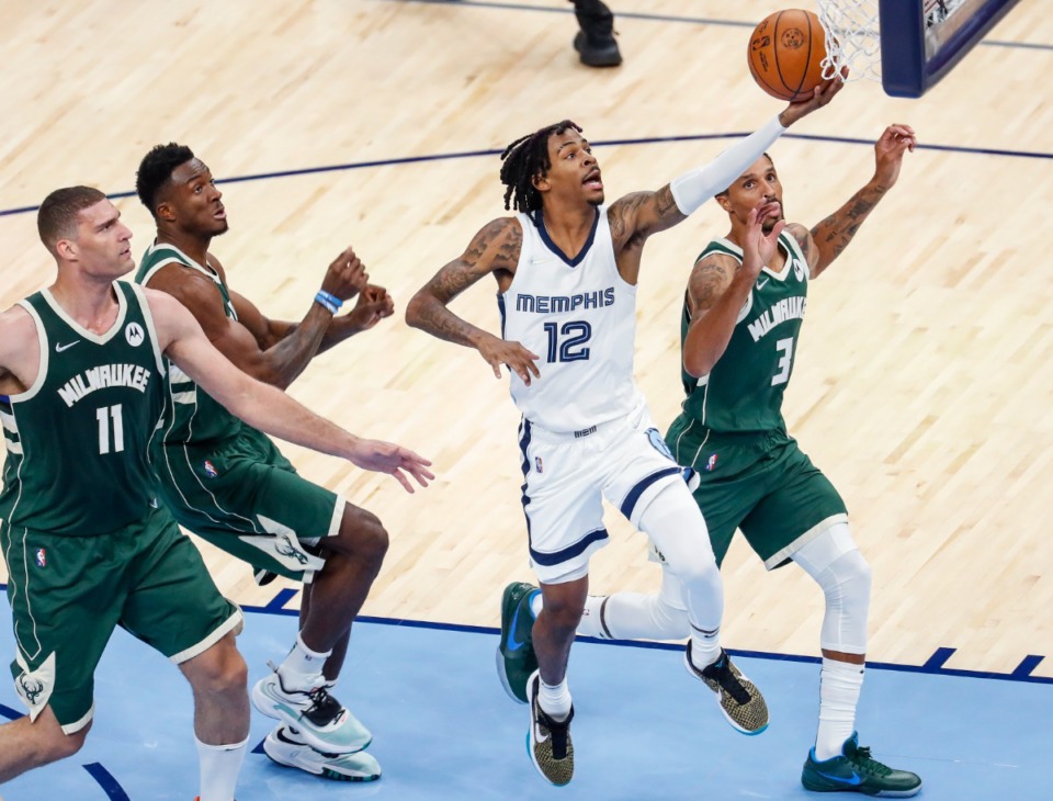 <strong>Memphis Grizzlies guard Ja Morant (middle) drives for a layup against the Milwaukee Bucks on Tuesday, Oct. 5, 2021.</strong> (Mark Weber/The Daily Memphian)