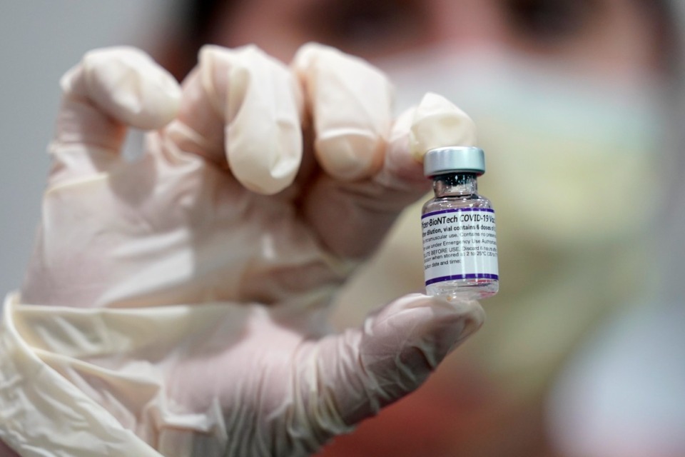 <strong>A healthcare worker holds a vial of the Pfizer COVID-19 vaccine at Jackson Memorial Hospital in Miami. Pfizer asked the U.S. government Thursday, Oct. 7, 2021, to allow use of its COVID-19 vaccine in children ages 5 to 11 -- and if regulators agree, shots could begin within a matter of weeks.</strong> (AP Photo/Lynne Sladky, File)