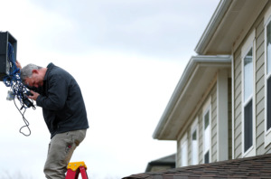 <strong>Daryl Whalen, an employee for OGN Tech, inspects and installs new security surveillance equipment in the Cleaborn Pointe at Heritage Landing neighborhood. Federal officials say the city of Memphis improperly used federal funding and are seeking to get the funds back.</strong> (Houston Cofield/Daily Memphian)