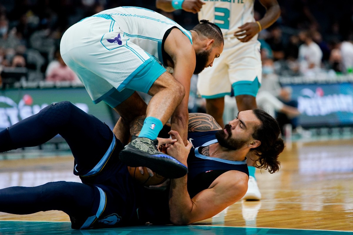 <strong>Charlotte forward Cody Martin and Memphis&rsquo; Steven Adams struggle to get possession of the ball</strong>&nbsp;<strong>on Oct. 7, 2021, in Charlotte, North Carolina.</strong> (Chris Carlson/AP)