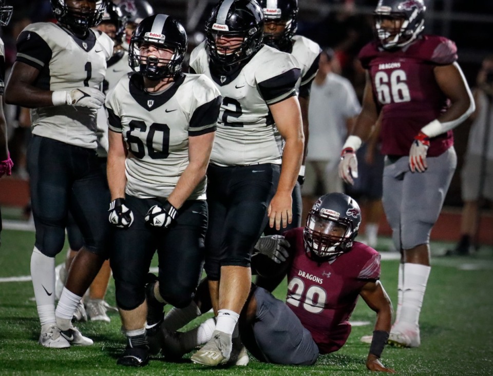 <strong>Houston&rsquo;s Devon Wilkerson (60), left, celebrates a tackle against Collierville running back Troy Martin (right) on Oct. 7, 2021.</strong> (Mark Weber/The Daily Memphian)