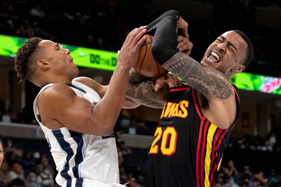 <strong>Memphis Grizzlies guard Desmond Bane (left) tangles up Atlanta Hawks forward John Collins resulting in a jump ball in the first half of the preseason game Saturday, Oct. 9, at FedExForum.</strong>&nbsp;<strong>The Grizzlies lost, 91-87.</strong> (Nikki Boertman/Associated Press)