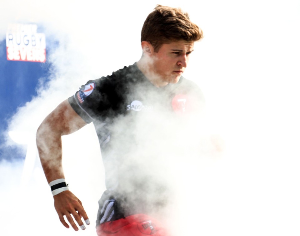 <strong>Players run through the smoke before a match during the Premier Rugby Sevens Inaugural Championship at AutoZone Park on Saturday, Oct. 9.</strong> (Patrick Lantrip/Daily Memphian)