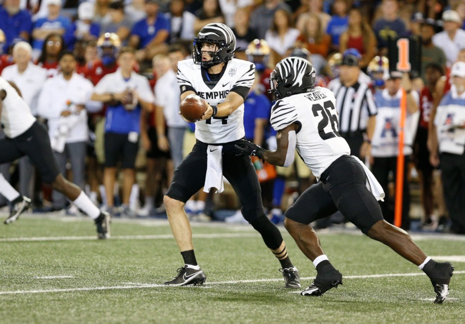 <strong>Memphis Tigers quarterback Seth Henigan (14) hands the ball off to running back Marquavius Weaver (26) against Tulsa on Saturday, Oct. 9, in Tulsa. The Tigers lost, 35-29.&nbsp;</strong> (Joey Johnson/Special to the Daily Memphian)