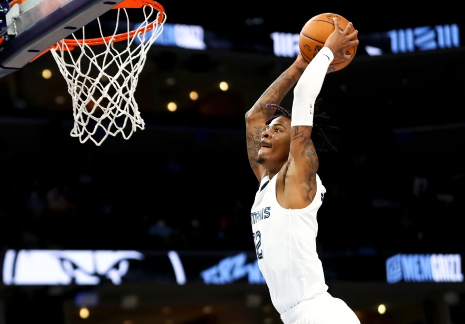 <strong>Grizzlies guard Ja Morant (12) goes up for a dunk during the Oct. 11, 2021, preseason game against the Detroit Pistons.</strong> (Patrick Lantrip/Daily Memphian)