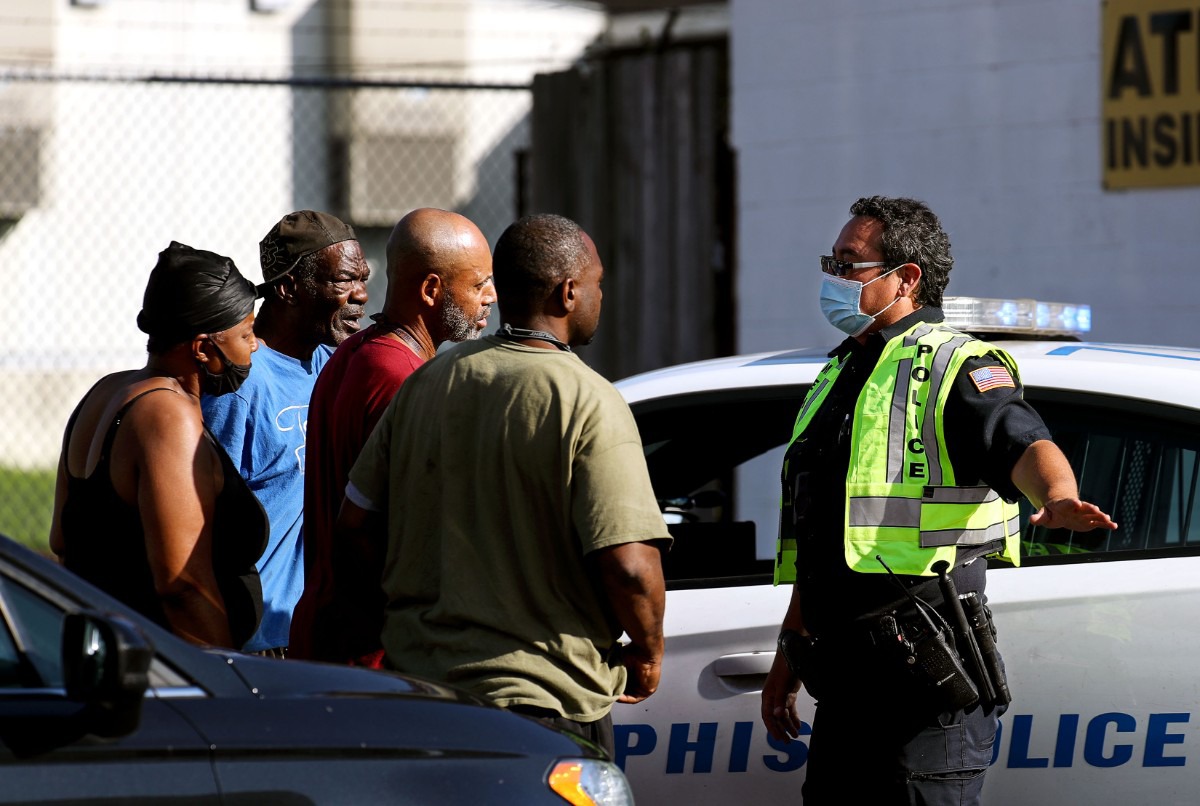 <strong>Memphis Police Department officers talk to residents of Orange Mound after a shooting at a nearby postal facility Oct. 12, 2021.</strong> (Patrick Lantrip/Daily Memphian)