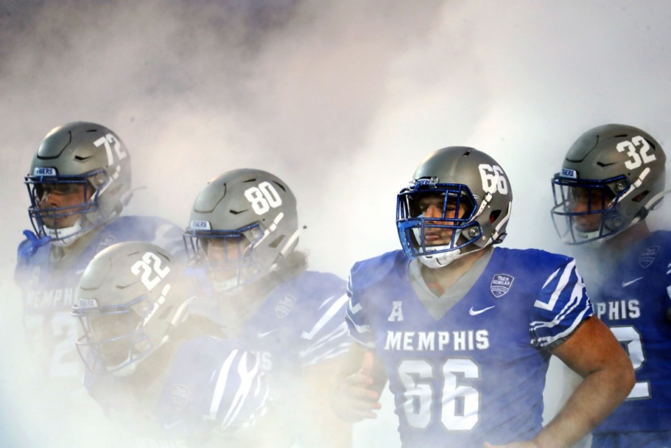 <strong>University of Memphis players take the field amid a cloud of smoke before the Oct. 14 game against Navy at the Liberty Bowl.</strong> (Patrick Lantrip/Daily Memphian)