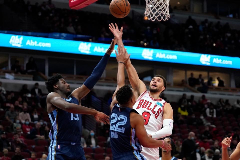 <strong>Chicago&rsquo;s Zach LaVine (8) shoots over Grizzlies forward Jaren Jackson Jr. (13) and Desmond Bane&nbsp;on Oct. 15 in Chicago.</strong> (Charles Rex Arbogast/AP)