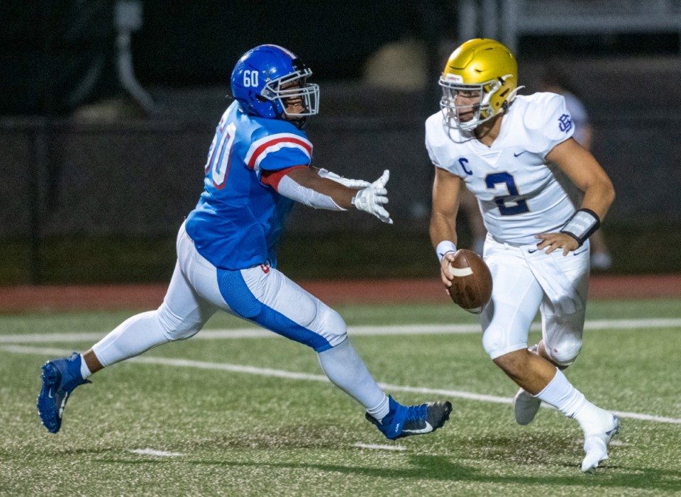 <strong>CBHS quarterback Ashton Strother (2) is chased out of the pocket by MUS defensive lineman Dion Stutts (60) on Oct. 15. (</strong>Greg Campbell/Special to The Daily Memphian)