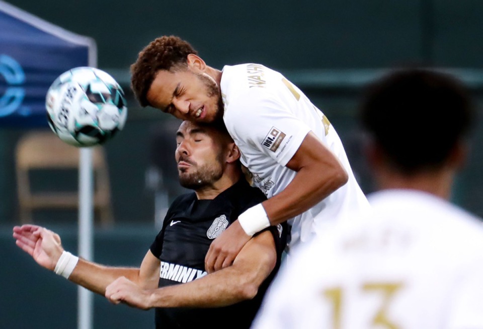 <strong>Memphis 901 FC forward Kyle Murphy (9) fights for a header during an Oct. 16, 2021 game at AutoZone Park against Atlanta United 2.</strong> (Patrick Lantrip/Daily Memphian)