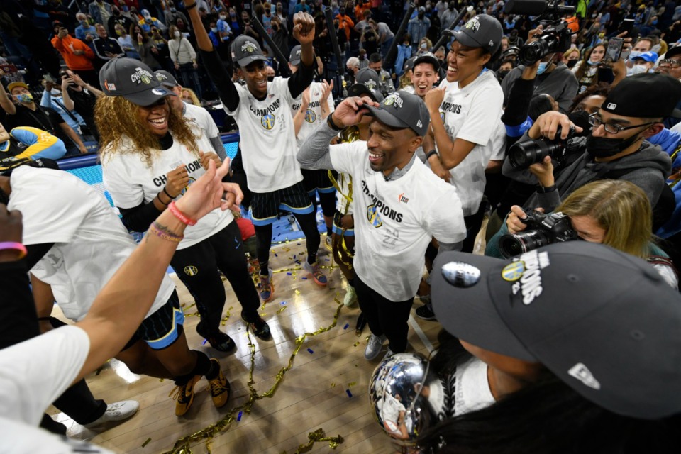 <strong>Chicago Sky head coach James Wade (center, right) celebrates with his players after they defeated the Phoenix Mercury in Game 4 of the WNBA Finals to become champions Sunday, Oct. 17, 2021, in Chicago.</strong> (AP Photo/Paul Beaty)