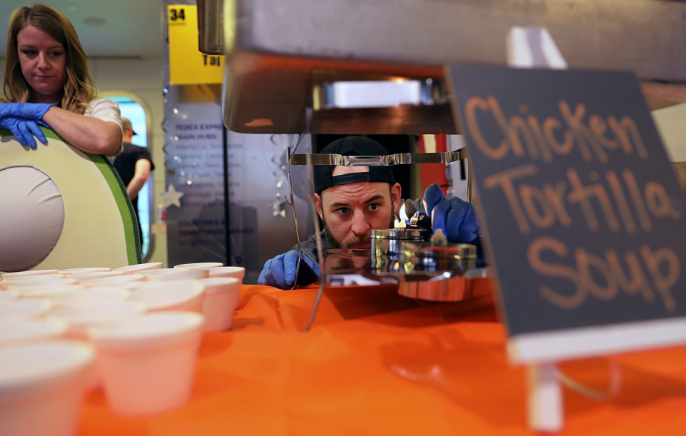 <strong>Chris O&rsquo;Neal of Babalu Tapas &amp; Tacos lights a chaffing dish canister to keep his Chicken Tortilla Soup warm while Courtney Hooper looks on during Soup Sunday.</strong> (Patrick Lantrip/Daily Memphian)