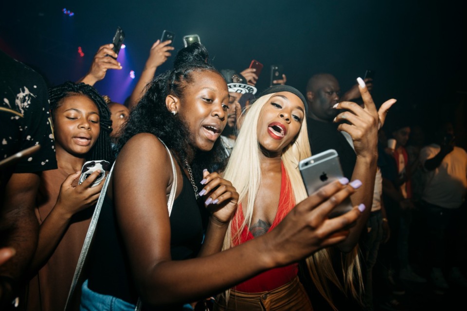 <strong>Moneybagg Yo fans send Snapchat videos on stage during his performance at Minglewood Hall in 2017.</strong> (Houston Cofield/Daily Memphian file)