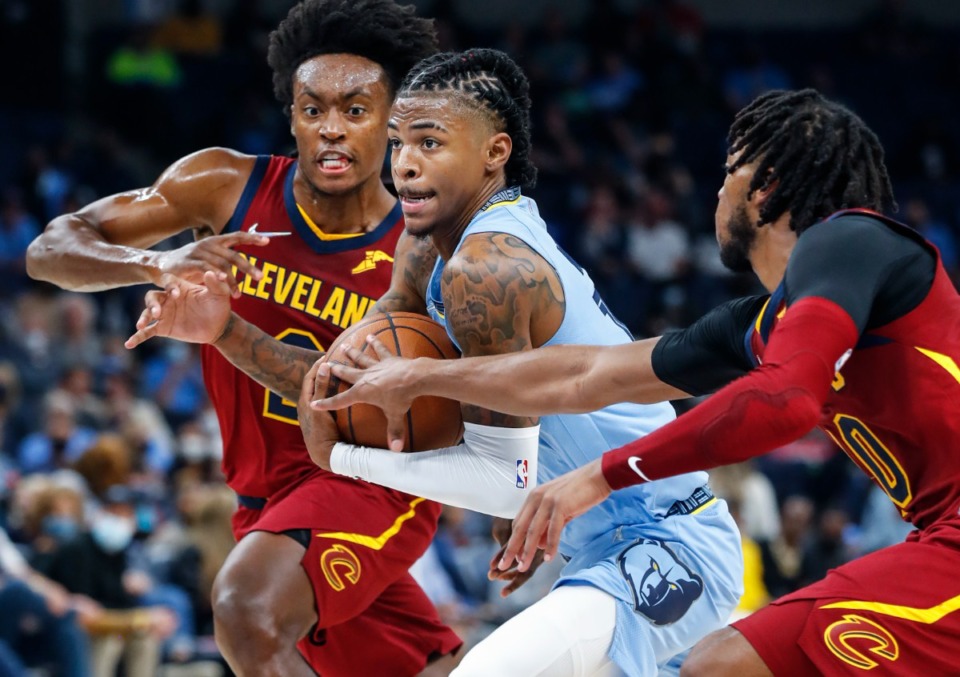 <strong>Grizzlies guard Ja Morant (middle) drives the lane against Cleveland&rsquo;s Collin Sexton (left) on Wednesday, Oct. 20, 2021.</strong> (Mark Weber/The Daily Memphian)