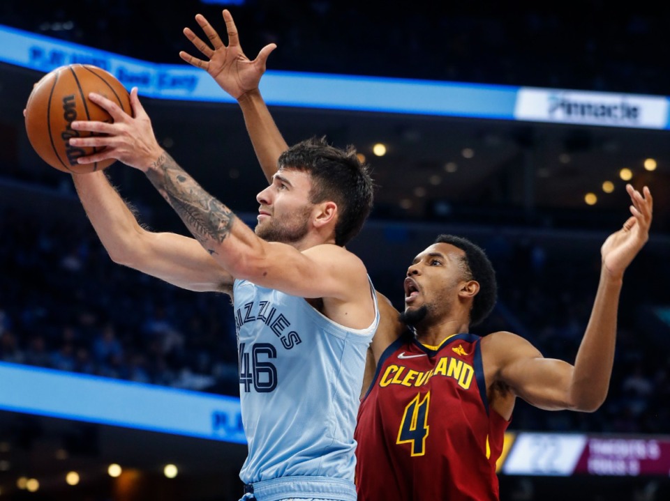 <strong>Grizzlies guard John Konchar (left) drives for a layup against Cleveland&rsquo;s Evan Mobley (right) on Wednesday, Oct. 20, 2021.</strong> (Mark Weber/The Daily Memphian)