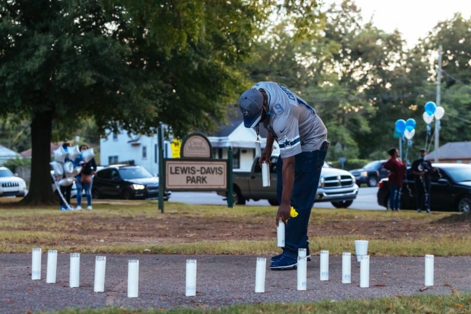 <strong>Joshua Moore organizes candles for the vigil of slain USPS employee Demetria Dortch at Lewis-Davis Park in Orange Mound&nbsp;on Oct. 20, 2021.</strong> (Ziggy Mack/Special to The Daily Memphian)