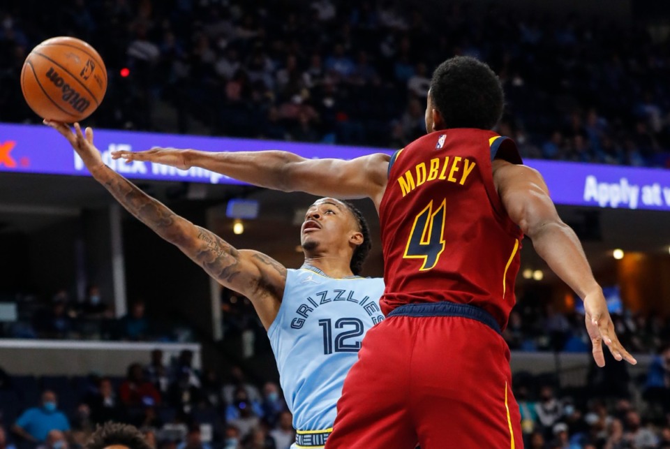 <strong>Grizzlies guard Ja Morant (left) drives for a layup against Cleveland&rsquo;s Evan Mobley (right) in the season opener on Wednesday, Oct. 20, 2021, at FedExForum. Morant scored 37 in the winning effort.</strong> (Mark Weber/The Daily Memphian)