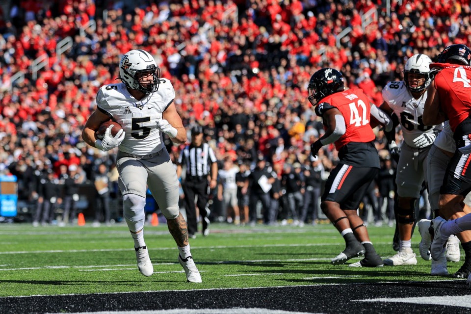 <strong>UCF running back Isaiah Bowser (5) carries the ball for a touchdown Oct. 16 against Cincinnati. The Knights are top 30 in rushing yards, with an average 204.17 per game.</strong> (Aaron Doster/AP file)