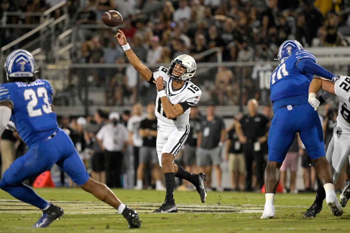 <strong>Central Florida quarterback Mikey Keene (16) passes as Memphis linebacker JJ Russell (23) and defensive lineman Morris Joseph (10) close in on Oct. 22, 2021, in Orlando, Florida.</strong> (Phelan M. Ebenhack/Orlando Sentinel via AP)