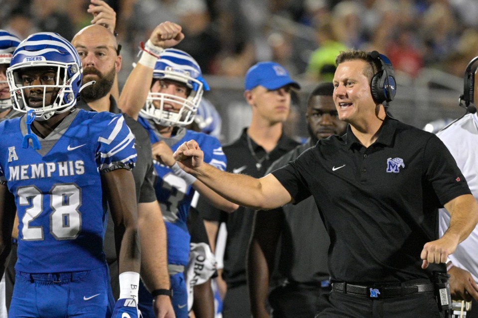 <strong>Memphis coach Ryan Silverfield, right, celebrates after a touchdown by running back Brandon Thomas during the first half of the team's NCAA college football game against Central Florida on Oct. 22, 2021, in Orlando, Florida.</strong> (Phelan M. Ebenhack/Orlando Sentinel via AP)