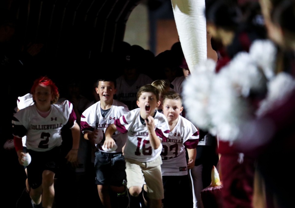 <strong>Collierville youth football players run through the tunnel before the Oct. 22 varsity game against Bartlett.</strong> (Patrick Lantrip/Daily Memphian)