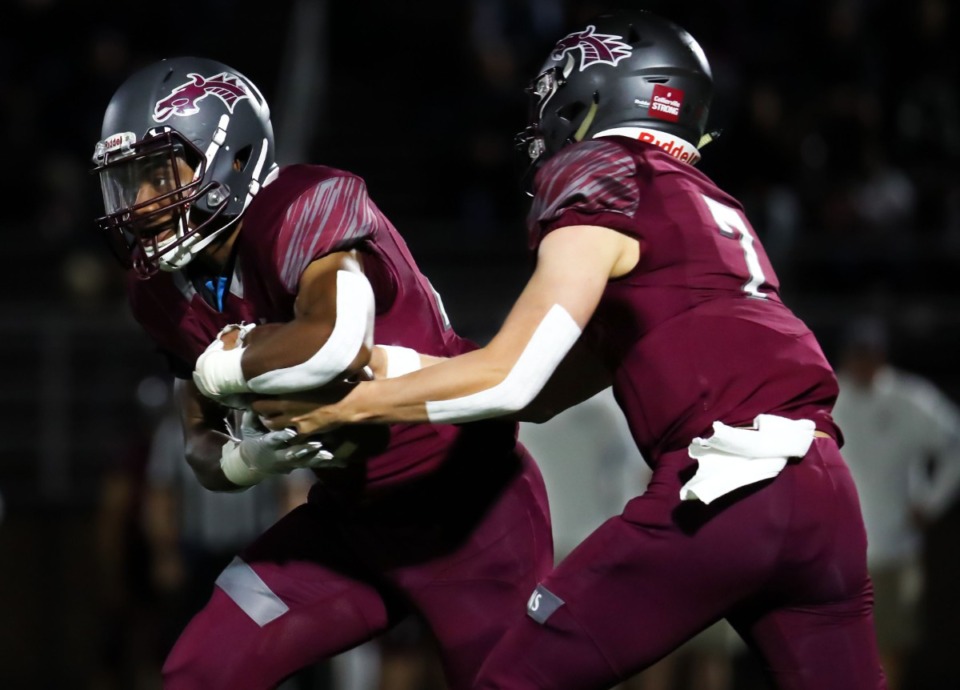 <strong>Collierville quarterback Houston Wilhelm (7) hands off to running back Troy Martin (29) during the Oct. 22 game against Bartlett.</strong> (Patrick Lantrip/Daily Memphian)